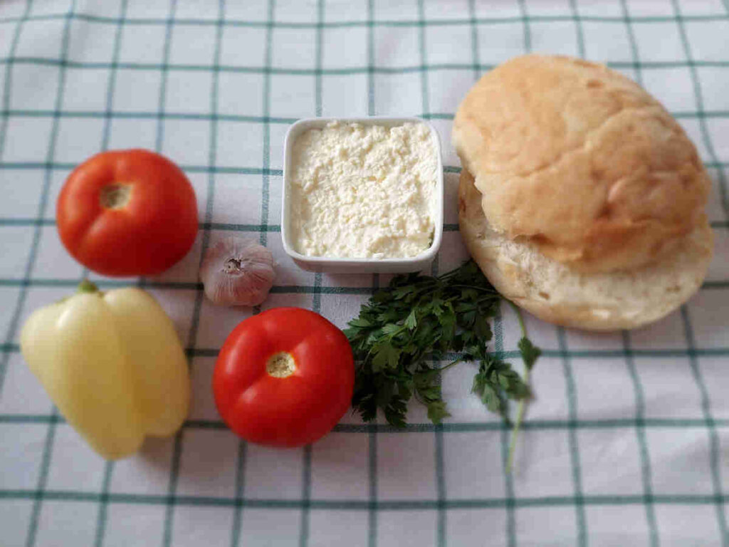 Kajmak served on the table alongside lepinja and vegetables