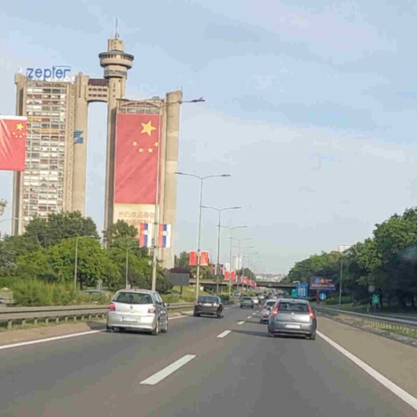 Chinese flags adorn the highway in Belgrade and the Genex Tower